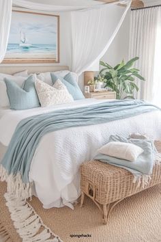 a bed with white sheets and blue pillows in a bedroom next to a painting on the wall