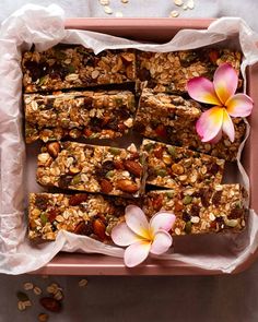 an overhead view of granola bars in a pink tray with flowers on the side