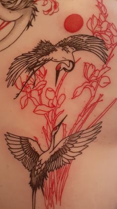 the back of a woman's stomach with flowers and birds on it in red ink