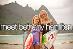 two beautiful young women standing next to each other on a beach with surfboards in their hands