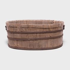 an old wooden barrel with straps on the bottom and sides, sitting in front of a white background