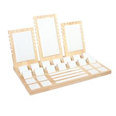 an assortment of wooden frames with white squares on them