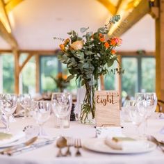 the table is set with flowers and place settings