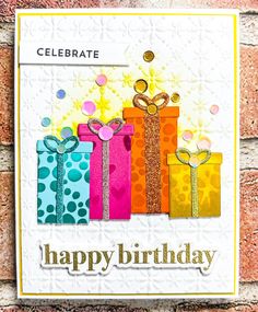 a birthday card with presents on it and the words celebrate written in gold, pink, blue, yellow and green