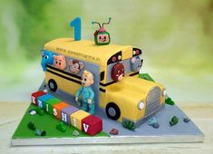 a birthday cake made to look like a school bus with characters on the front and sides