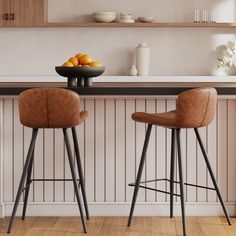 two stools in front of a counter with oranges on it and bowls of fruit