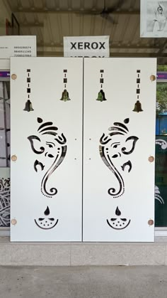 two large white doors with designs on them