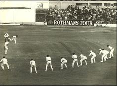 a group of men standing on top of a baseball field