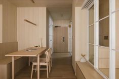 an empty room with wooden walls and flooring is seen in this image from the hallway to the dining area