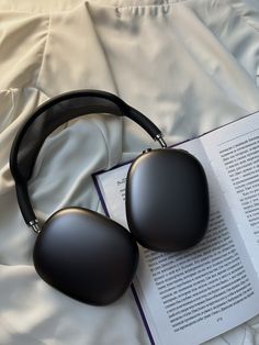 headphones resting on top of an open book