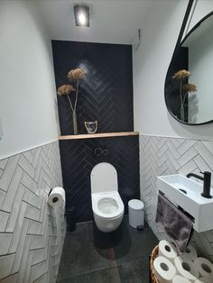 a bathroom with black and white tile walls