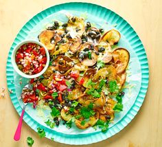 a white plate topped with grilled vegetables next to a bowl of salsa and corn on the cob