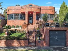 a large brick house with lots of windows