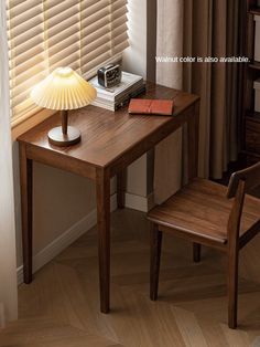 a small wooden table with a lamp on it next to a book shelf and chair