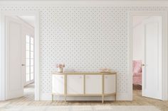 an empty room with white walls and polka dot wallpaper