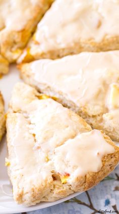 a white plate topped with scones covered in icing