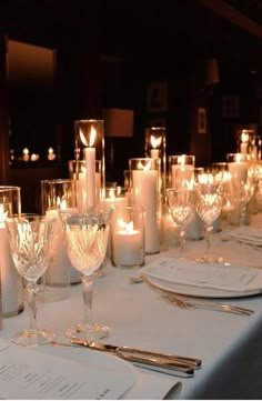 a long table is set with candles and place settings