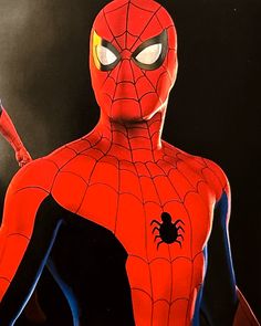 a man in a spider - man suit with his hands on his hips and eyes open