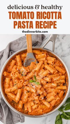 a pan filled with pasta and sauce on top of a table