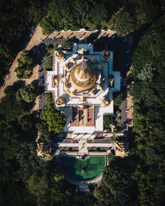 an aerial view of a building surrounded by trees