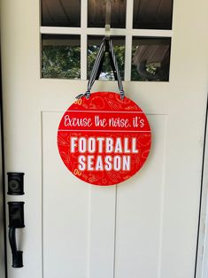 a red sign that says because the noise it's football season hangs on a door