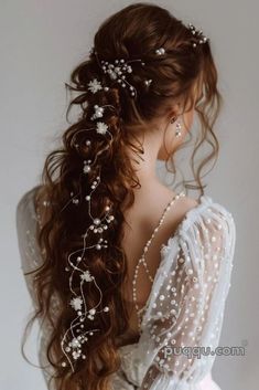 a woman with long hair wearing a white dress and pearls on it's head