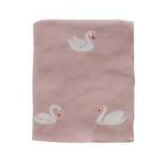 a pink towel with white swans on it