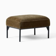 the foot stool is made from wood and has a brown upholstered fabric cover