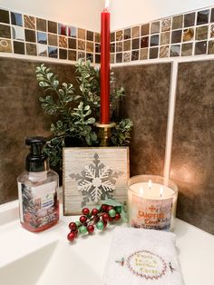 a candle and some christmas decorations in a bathroom