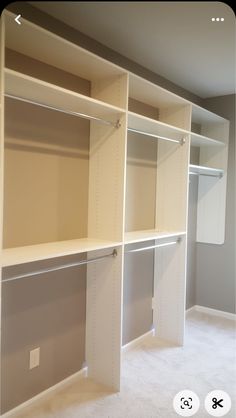 an empty room with white shelves and carpet