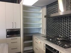 a kitchen with an oven, stove and cabinets in the room that has no one inside