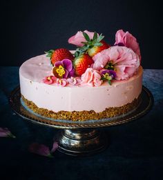 a cake with pink frosting and flowers on top