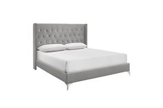 a bed with white sheets and grey headboard on it's side, in front of a white background