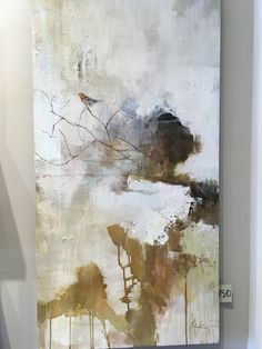 an abstract painting is displayed on the wall