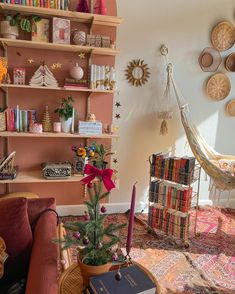 a living room filled with furniture and bookshelves next to a hammock