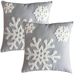 two gray and white pillows with snowflakes on them