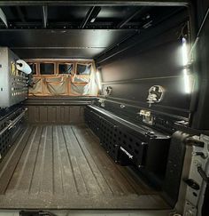 the back end of a truck with its cargo doors open and two ovens in it