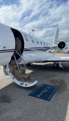 a private jet parked on the tarmac at an airport