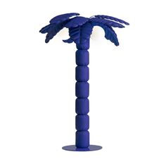 a blue plastic palm tree on a white background