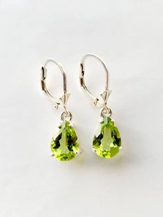 Peridot dangle earrings in Silver or Gold. Natural Peridot 10mm x 7mm genuine stones set in Sterling Silver handmade settings.  The Peridot are about 3 carats total and a very nice green color.  The settings for these Peridot drop earrings are handmade by me and the lovely Peridot hang down from lever backs which keep them safely in your ears.  Peridot is the birthstone for August.  These lovely Peridot earrings make a great gift for all ages.  I can also sell just one piece, please convo me if Green Pear-shaped Gemstone Earrings, Pear-shaped Green Gemstone Earrings, Classic Green Pear Shaped Earrings, Elegant Lime Green Earrings For Formal Occasions, Classic Green Pear-shaped Earrings, Elegant Lime Green Earrings For Formal Events, Classic Teardrop Earrings For May Birthstone, Classic Teardrop May Birthstone Earrings, Classic Green Drop Earrings