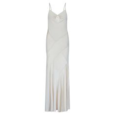 This dress was designed by Blumarine in the early 2000s and tailored from a patchwork of matte and satin fine knit jerseys in a soft creamy champagne hue. The bias-cut recalls the simple grace of 1930s’ silhouettes, skimming the body and highlighting the wearer's curves. The pretty straps are twisted from strips of satin and matte cloth. The bust is gathered, forming a sweetheart neckline and the back is low and skin-revealing. The dress is unlined except at the bust and top of the back where it is lined in champagne mesh. The gown falls to a floor-sweeping length that only adds to the glamour of the design. This hyper-feminine, romantic fashion brand was founded in 1977 by husband-and-wife duo, Anna Molinari and Gianpaolo Tarabini. The name Blumarine was inspired by the vivid blue of the Cream Slip Dress, Color Champagne, The Early 2000s, Fine Knit, Romantic Style, Early 2000s, Dress Clothes For Women, The Pretty, Fit Inspo