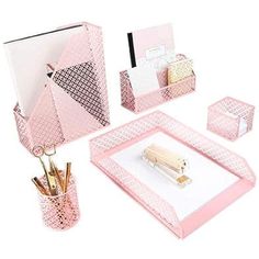 the pink desk set is organized with pens, pencils, and other office supplies