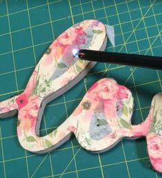 the scissors are laying on top of the flowered fabric and have been cut out