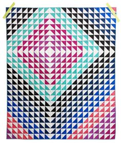 a quilt made with different colored squares and triangles on the front, side, and back