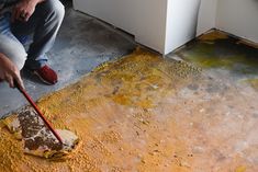 a man is cleaning the floor with a mop