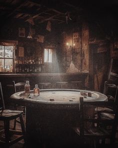 a round table with chairs around it in a room that has wooden walls and beams