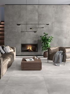 a living room filled with furniture and a fire place next to a wall mounted fireplace