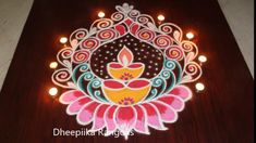 an intricately decorated diya with lit candles