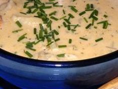 a blue bowl filled with soup and bread