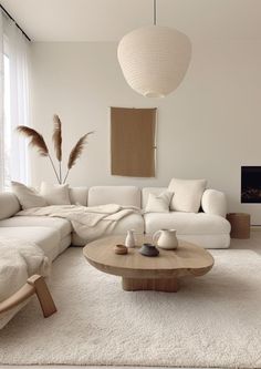 a living room filled with furniture and a large white couch in front of a window